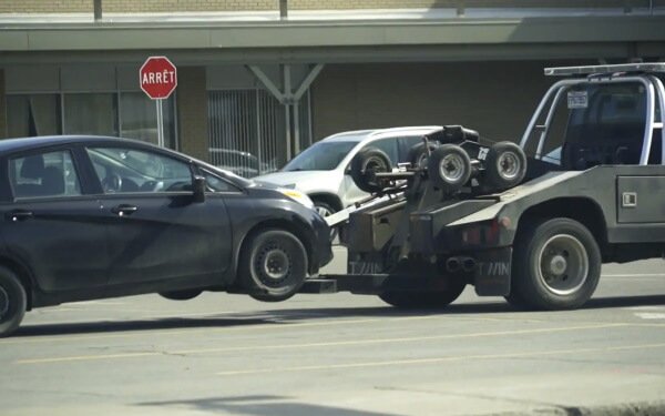 Moving the car by the black tow truck