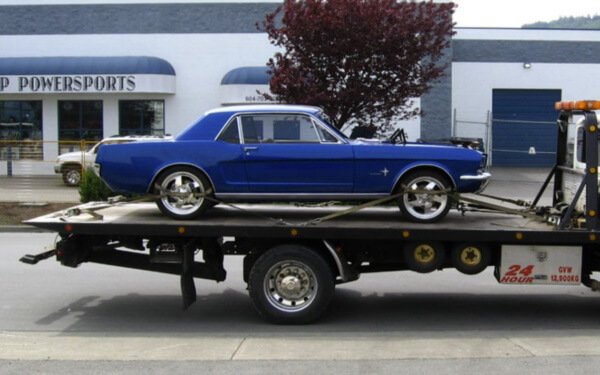 Classic car on tow truck