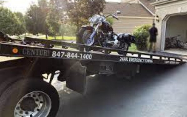 Black motorcycle flatbed tow truck